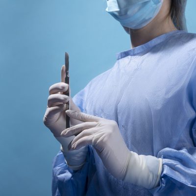 female-doctor-holding-metallic-medical-scalpel